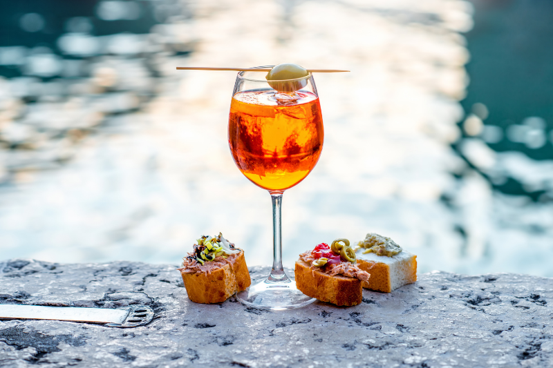 An Aperol Spritz with the classic small bite Cicchetti in Venice.